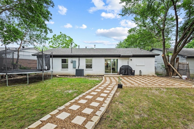 1807 W Belden St, Sherman, TX 75092 - rear view of property with a trampoline, central air condition unit, a patio, and brick siding