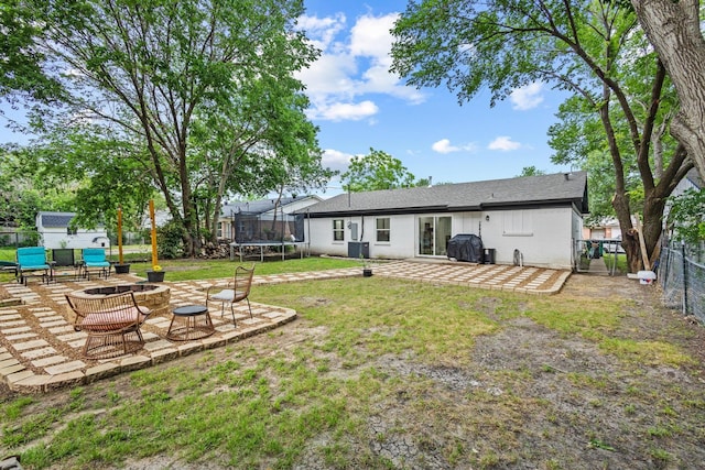 1807 W Belden St, Sherman, TX 75092 - view of yard with a trampoline, a patio, an outdoor fire pit, and central AC