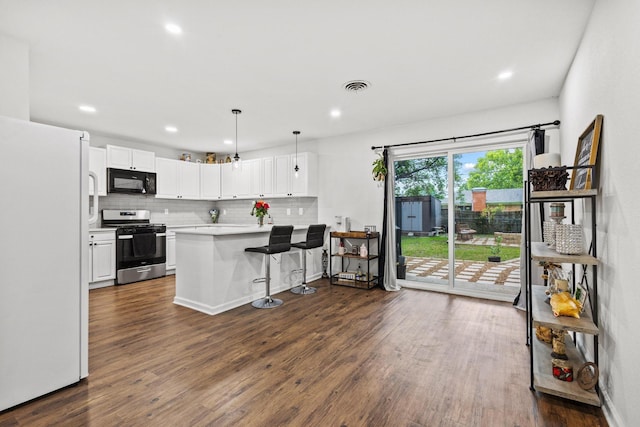 1807 W Belden St, Sherman, TX 75092 - kitchen with black microwave, freestanding refrigerator, gas stove, tasteful backsplash, and white cabinetry