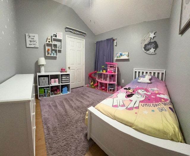 7568 Casburn Ct, Fort Worth, TX 76120 - bedroom with vaulted ceiling and wood finished floors