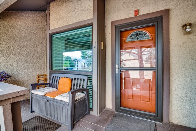 4559 N O Connor Rd Unit 2289, Irving, TX 75062 - doorway to property featuring stucco siding and a porch