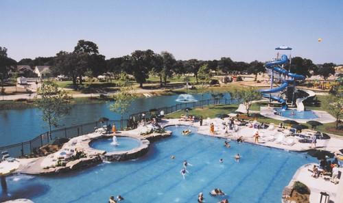 1341 Bristol Ln, Providence Village, TX 76227 - community pool featuring a water slide, a water view, and a jacuzzi