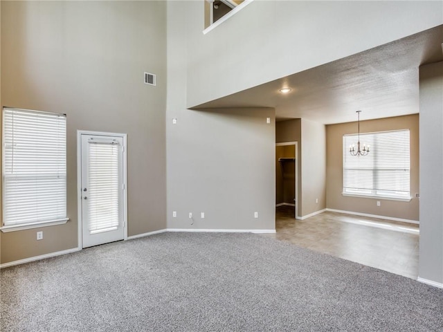1341 Bristol Ln, Providence Village, TX 76227 - spare room with a chandelier, carpet flooring, baseboards, and a towering ceiling