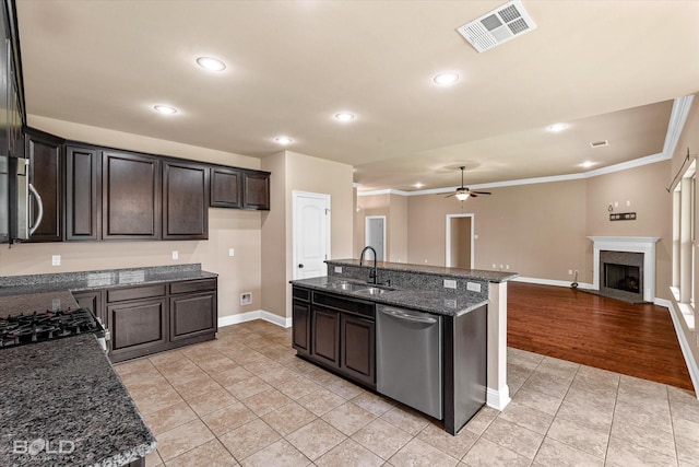 9214 Mykanos Trl, Shreveport, LA 71106 - kitchen featuring appliances with stainless steel finishes, baseboards, a sink, light tile patterned flooring, and open floor plan