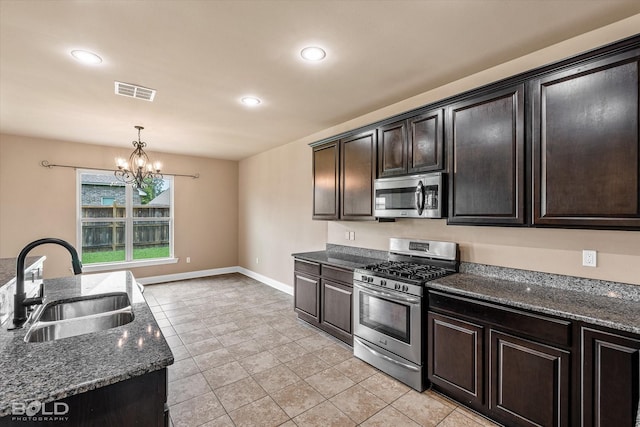 9214 Mykanos Trl, Shreveport, LA 71106 - kitchen featuring appliances with stainless steel finishes, a sink, recessed lighting, a chandelier, and decorative light fixtures
