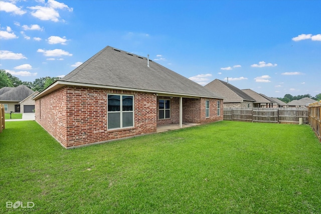 9214 Mykanos Trl, Shreveport, LA 71106 - back of house with brick siding, roof with shingles, and a patio area