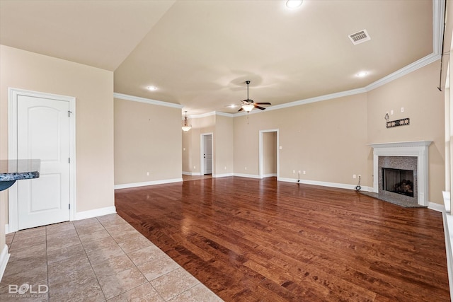9214 Mykanos Trl, Shreveport, LA 71106 - unfurnished living room with a high end fireplace, a ceiling fan, crown molding, recessed lighting, and baseboards