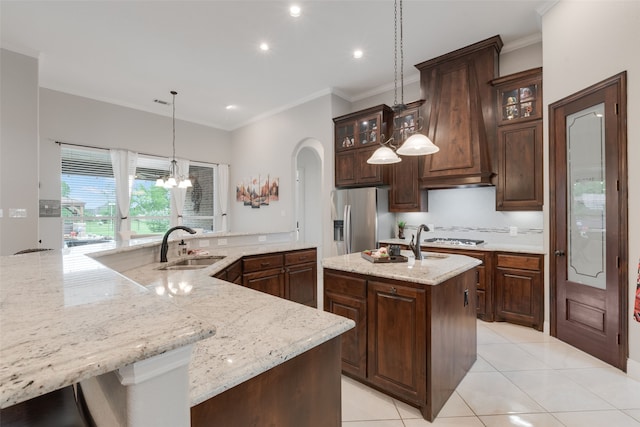 641 Hidden Pass, Royse City, TX 75189 - kitchen featuring a large island, stainless steel fridge, a sink, ornamental molding, and arched walkways