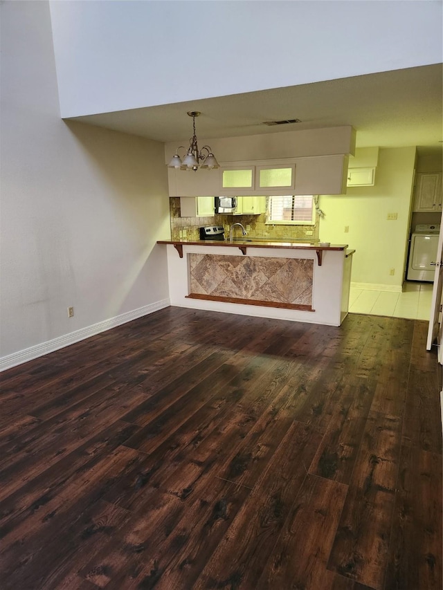 3636 Greenacres Place Dr Unit 45, Bossier City, LA 71111 - unfurnished living room with hardwood / wood-style floors, a chandelier, washer / dryer, and baseboards
