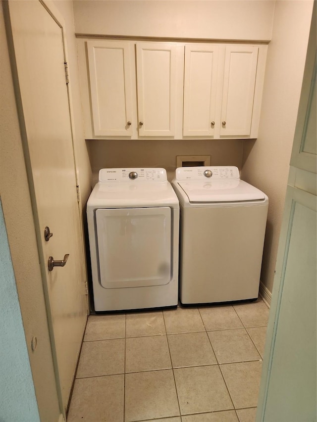 3636 Greenacres Place Dr Unit 45, Bossier City, LA 71111 - laundry area featuring washer and clothes dryer, cabinet space, light tile patterned flooring, and baseboards
