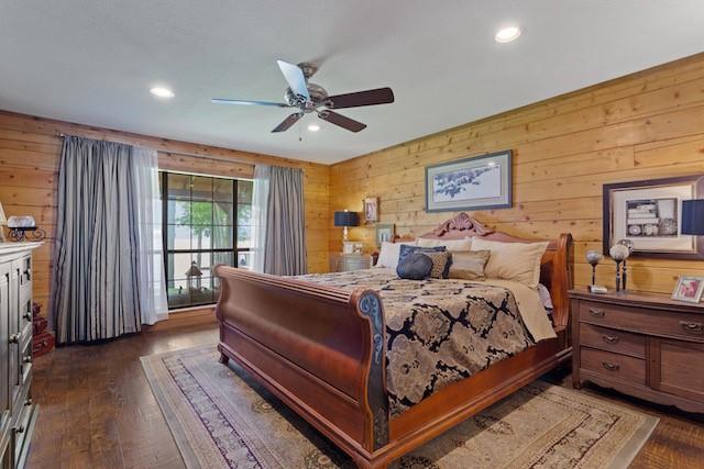 16887 Rainbow Ridge Cir, Tyler, TX 75707 - bedroom with wooden walls, dark wood-style flooring, recessed lighting, and a ceiling fan