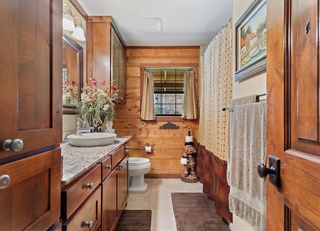 16887 Rainbow Ridge Cir, Tyler, TX 75707 - full bathroom with wooden walls, toilet, vanity, and tile patterned flooring