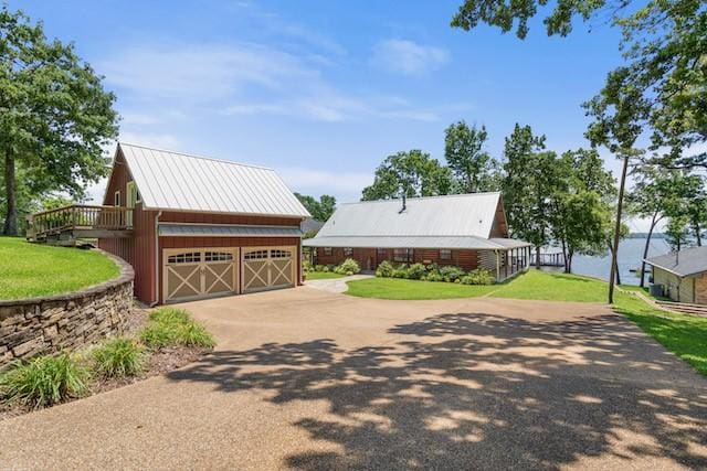 16887 Rainbow Ridge Cir, Tyler, TX 75707 - view of front facade with a front lawn, driveway, and metal roof