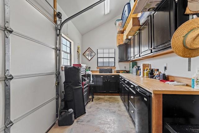 16887 Rainbow Ridge Cir, Tyler, TX 75707 - kitchen with concrete flooring, light countertops, high vaulted ceiling, and dark cabinetry