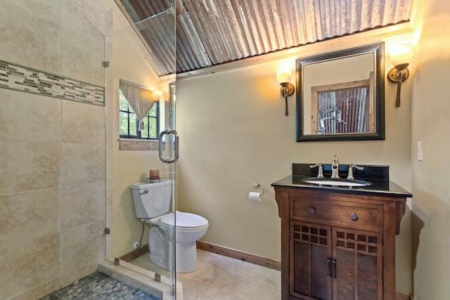 16887 Rainbow Ridge Cir, Tyler, TX 75707 - bathroom with toilet, vanity, a tile shower, and baseboards