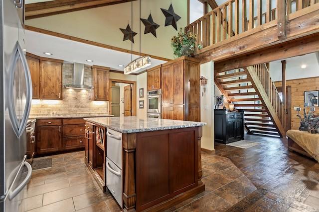 16887 Rainbow Ridge Cir, Tyler, TX 75707 - kitchen with wall chimney exhaust hood, appliances with stainless steel finishes, high vaulted ceiling, a kitchen island, and decorative backsplash