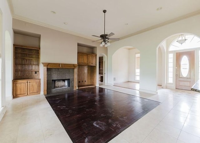 215 Harvest Rdg, Mclendon Chisholm, TX 75032 - unfurnished living room with built in features, light tile patterned floors, crown molding, ceiling fan, and a fireplace