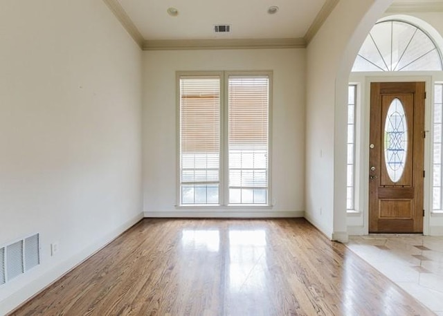 215 Harvest Rdg, Mclendon Chisholm, TX 75032 - entrance foyer with arched walkways, wood finished floors, crown molding, and baseboards