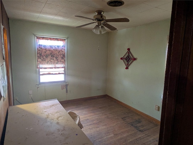 2214 N Woodland St, Amarillo, TX 79107 - spare room featuring wood finished floors, a ceiling fan, and baseboards