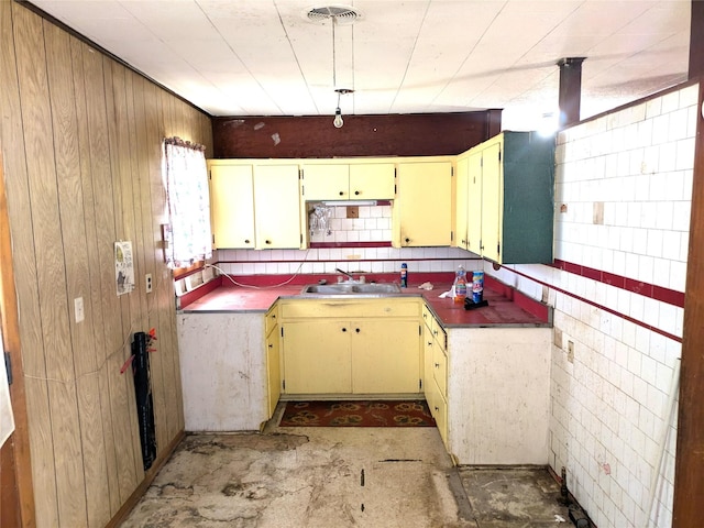 2214 N Woodland St, Amarillo, TX 79107 - kitchen with a sink, unfinished concrete flooring, and wooden walls