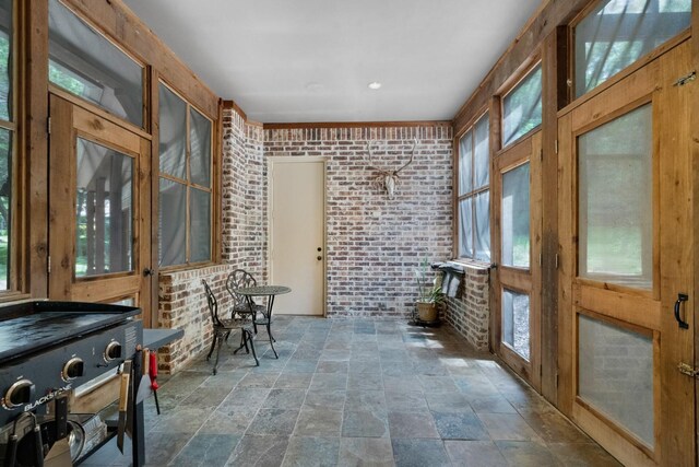 2306 Autumn Run Ct, Cedar Hill, TX 75104 - sunroom / solarium with brick wall, stone tile flooring, and healthy amount of natural light