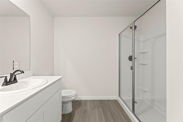 122 Doma Ave, Greenville, TX 75402 - bathroom featuring a shower stall, wood finished floors, and vanity