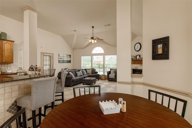 3404 Brookshire Run, Corinth, TX 76210 - dining room with a fireplace, a ceiling fan, and high vaulted ceiling