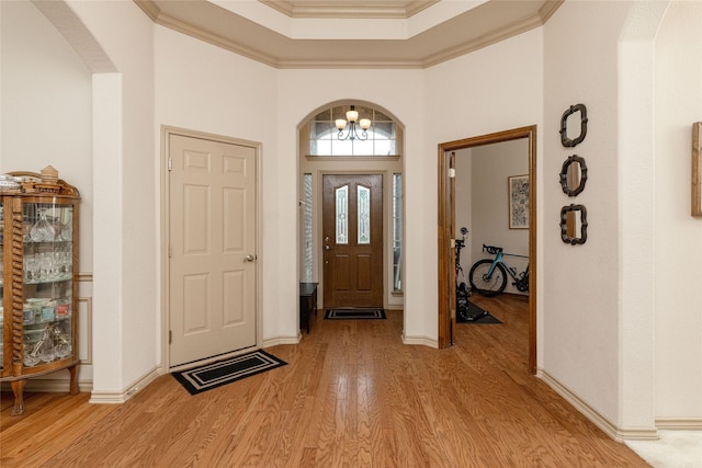 3404 Brookshire Run, Corinth, TX 76210 - entryway featuring arched walkways, light wood-type flooring, a chandelier, baseboards, and a towering ceiling