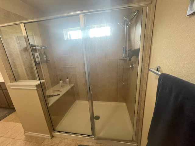 306 Valley Lake Ct, Springtown, TX 76082 - full bath featuring tile patterned floors, a stall shower, and a textured wall