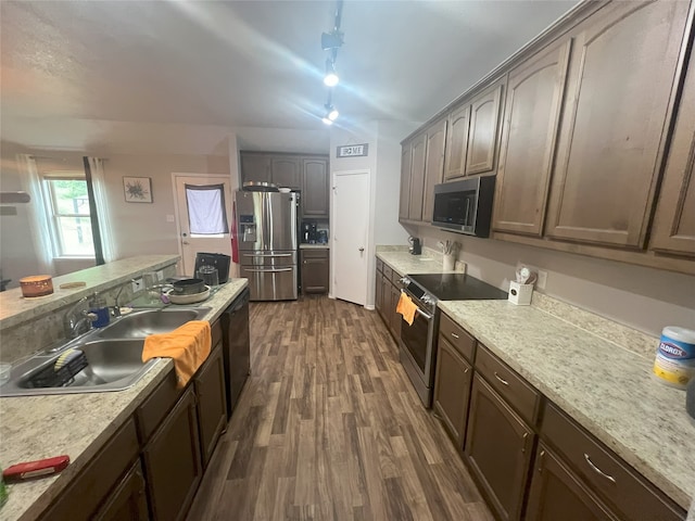 306 Valley Lake Ct, Springtown, TX 76082 - kitchen with stainless steel appliances, dark wood finished floors, a sink, light countertops, and track lighting