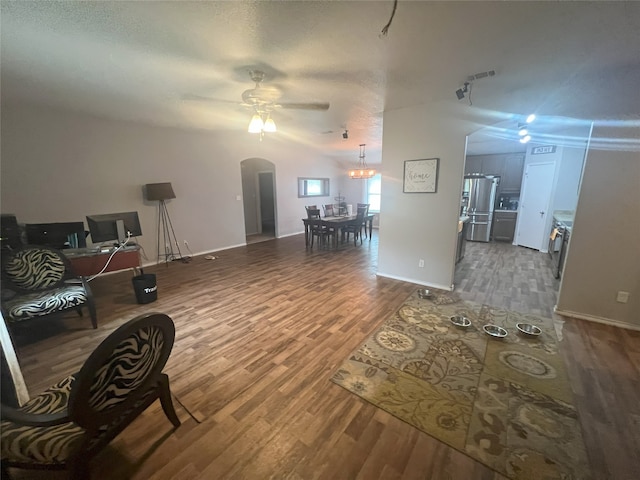 306 Valley Lake Ct, Springtown, TX 76082 - living area featuring a ceiling fan, wood finished floors, arched walkways, and baseboards