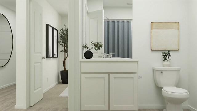 7730 Reese St, Dallas, TX 75114 - bathroom with toilet, baseboards, vanity, and wood finished floors