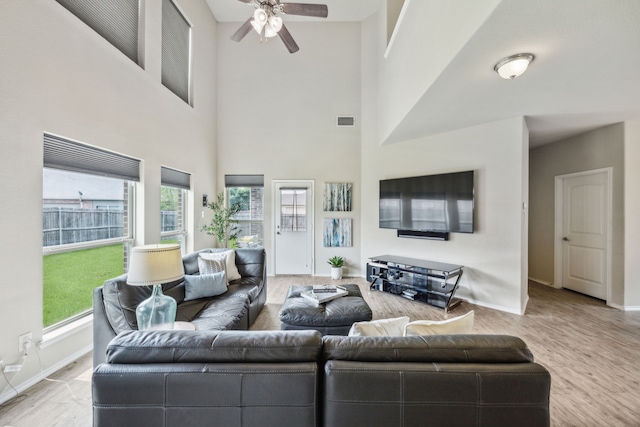 7502 Pacific Dr, Rowlett, TX 75088 - living room featuring baseboards, ceiling fan, a towering ceiling, and wood finished floors