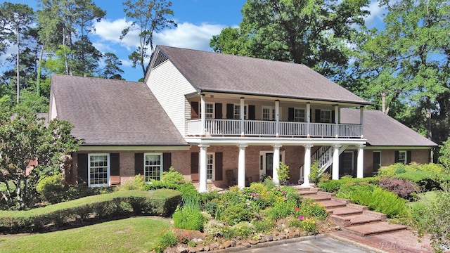 6706 Querbes Dr, Shreveport, LA 71106 - view of front of property with stairway, covered porch, a front yard, roof with shingles, and brick siding