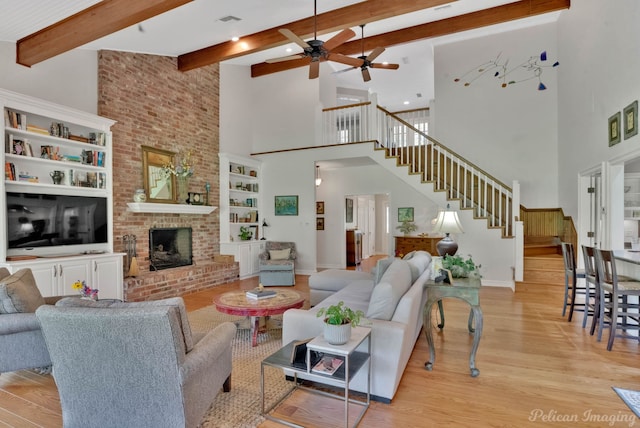6706 Querbes Dr, Shreveport, LA 71106 - living area featuring a high ceiling, light wood-style floors, stairway, ceiling fan, and beamed ceiling