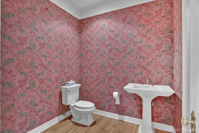6706 Querbes Dr, Shreveport, LA 71106 - half bathroom with wood finished floors, toilet, baseboards, and crown molding