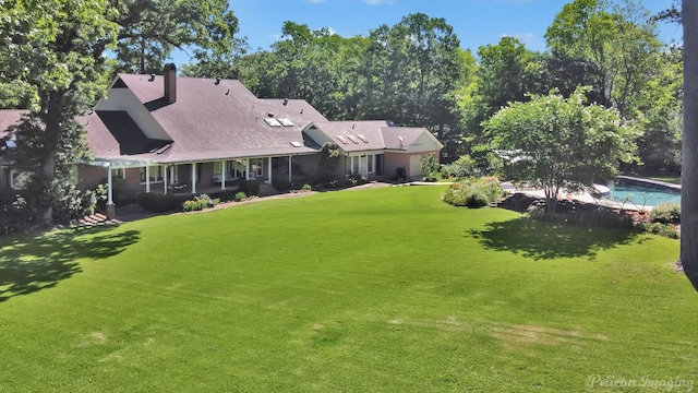 6706 Querbes Dr, Shreveport, LA 71106 - rear view of house with a lawn and a chimney
