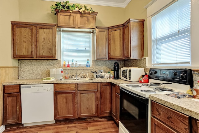 225 N Binkley St, Sherman, TX 75092 - kitchen featuring white appliances, a sink, plenty of natural light, crown molding, and light countertops