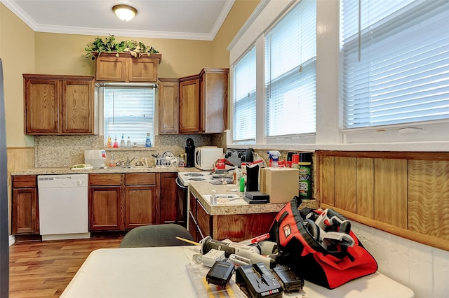 225 N Binkley St, Sherman, TX 75092 - kitchen featuring white dishwasher, plenty of natural light, brown cabinetry, light wood finished floors, and ornamental molding