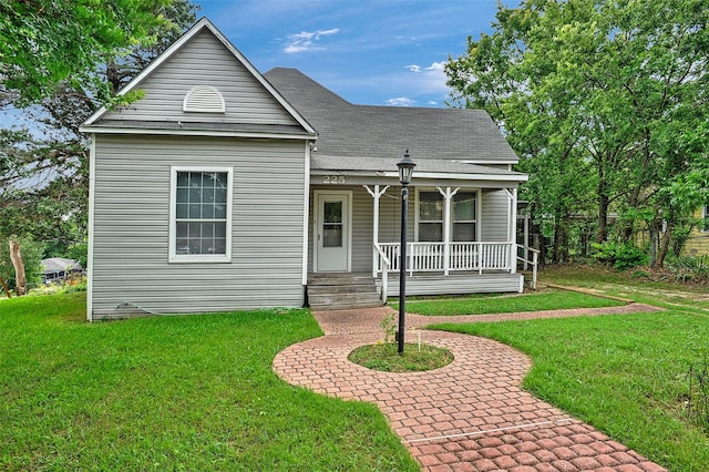 225 N Binkley St, Sherman, TX 75092 - view of front facade featuring covered porch, a front lawn, and a shingled roof