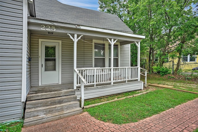 225 N Binkley St, Sherman, TX 75092 - entrance to property with a porch, a shingled roof, and fence