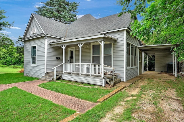 225 N Binkley St, Sherman, TX 75092 - view of front of house with a porch, a front yard, a carport, and roof with shingles