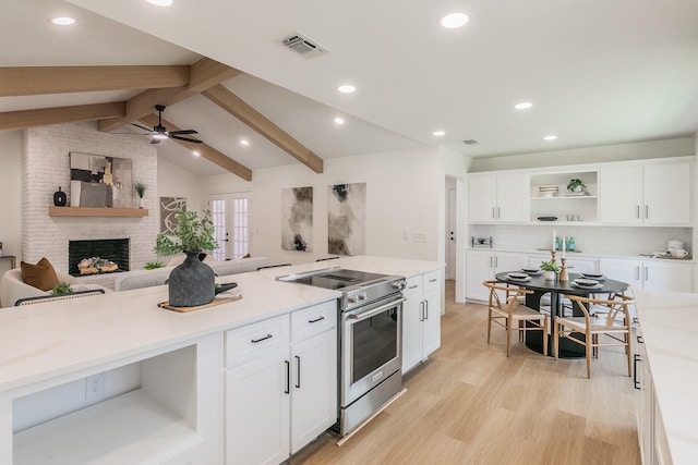 2505 Kelsey Dr, Plano, TX 75075 - kitchen with high end stainless steel range oven, open shelves, open floor plan, white cabinetry, and a fireplace