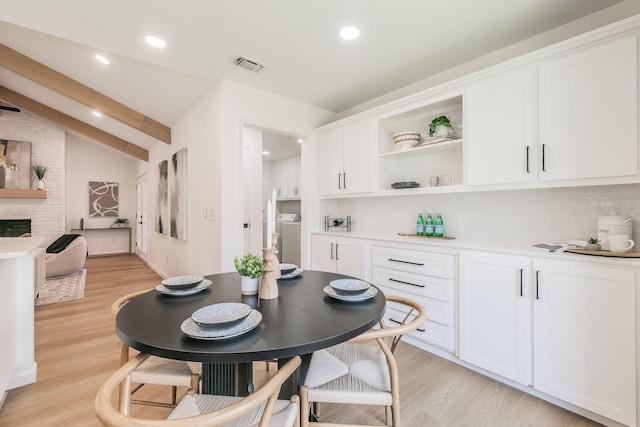 2505 Kelsey Dr, Plano, TX 75075 - dining space with light wood-style floors, recessed lighting, a fireplace, and washer / dryer