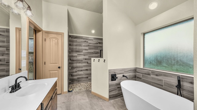 110 Emilie Ct, Weatherford, TX 76087 - full bathroom featuring tile walls, a freestanding bath, vanity, a tile shower, and vaulted ceiling