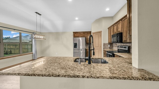 110 Emilie Ct, Weatherford, TX 76087 - kitchen featuring stainless steel appliances, light stone counters, tasteful backsplash, a sink, and recessed lighting