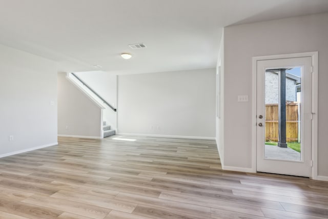 3010 Isla Ter, Princeton, TX 75407 - empty room with light wood-style flooring, stairs, and baseboards