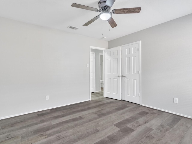 401 Iron Ore Trl, Fort Worth, TX 76131 - unfurnished bedroom featuring wood finished floors, baseboards, a ceiling fan, and a closet