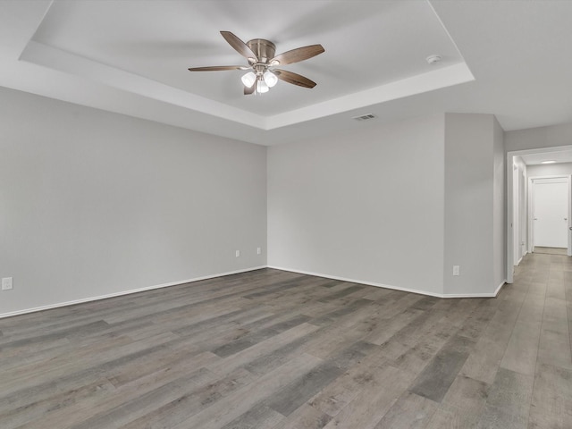 401 Iron Ore Trl, Fort Worth, TX 76131 - spare room with a tray ceiling, ceiling fan, wood finished floors, baseboards, and a smoke detector