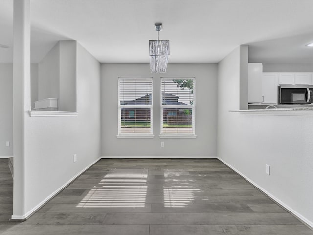 401 Iron Ore Trl, Fort Worth, TX 76131 - unfurnished dining area with wood finished floors, baseboards, and a chandelier